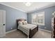 Inviting bedroom with hardwood bed frame and a chest of drawers at 3138 Curling Creek Dr, Apex, NC 27502