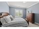 Cozy bedroom features wood furniture, neutral carpet and lots of natural light at 3138 Curling Creek Dr, Apex, NC 27502