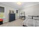 Cozy bedroom featuring a blue dresser and desk, illuminated by natural light at 3138 Curling Creek Dr, Apex, NC 27502