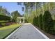 Bocce ball court and putting green surrounded by lush landscaping and tall trees at 3138 Curling Creek Dr, Apex, NC 27502