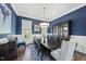 Formal dining room with elegant decor, a large table, and an accent wall at 3138 Curling Creek Dr, Apex, NC 27502
