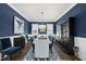 Formal dining room with dark wood table and dark blue accent wall at 3138 Curling Creek Dr, Apex, NC 27502