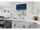 Kitchen sink area featuring stainless steel appliances and contemporary white cabinetry at 3138 Curling Creek Dr, Apex, NC 27502