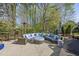 Relaxing outdoor seating area with comfortable furniture, gas heater, and view of the natural wooded backyard at 3138 Curling Creek Dr, Apex, NC 27502