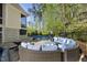 Backyard patio area featuring a pool, hot tub, and outdoor seating with plush blue cushions at 3138 Curling Creek Dr, Apex, NC 27502