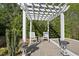 A pergola features seating with a table between the two chairs. Decorative pots are in front of the chairs at 3138 Curling Creek Dr, Apex, NC 27502