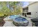 Backyard pool area with stone hot tub and covered patio, perfect for outdoor entertaining at 3138 Curling Creek Dr, Apex, NC 27502