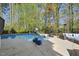 Backyard pool with patio seating and wooded views offers a relaxing outdoor experience at 3138 Curling Creek Dr, Apex, NC 27502