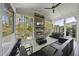 Cozy screened porch featuring a stone fireplace, comfortable seating, and a view of the serene backyard at 3138 Curling Creek Dr, Apex, NC 27502