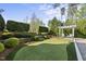A putting green surrounded by manicured landscaping, including a bocce ball court and a pergola at 3138 Curling Creek Dr, Apex, NC 27502