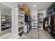Spacious walk-in closet with custom shelving, ample hanging space, and mirrored accent wall at 3138 Curling Creek Dr, Apex, NC 27502