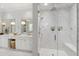 Elegant bathroom featuring a marble-walled shower, double vanity with gold fixtures, and marble tile flooring at 3312 Rock Creek Dr, Raleigh, NC 27609