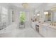 Spa-like bathroom with double vanity, soaking tub, and bright natural light at 3312 Rock Creek Dr, Raleigh, NC 27609