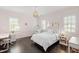Pink bedroom with dark wood floors, three windows with shutters, and a hanging chair at 3312 Rock Creek Dr, Raleigh, NC 27609