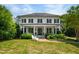 Charming two-story white home with black shutters, a brick walkway, and a well-manicured front yard at 3312 Rock Creek Dr, Raleigh, NC 27609