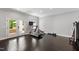 Bright home gym with wood floors, exercise equipment, and French doors leading to the outdoor patio at 3312 Rock Creek Dr, Raleigh, NC 27609