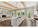 Bright kitchen with island featuring a stainless steel sink, and view of the living area at 3312 Rock Creek Dr, Raleigh, NC 27609