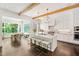 Bright, modern kitchen with a large marble island, white cabinets, and stainless steel appliances at 3312 Rock Creek Dr, Raleigh, NC 27609