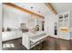 Spacious kitchen with white cabinets, marble countertops, and a large center island at 3312 Rock Creek Dr, Raleigh, NC 27609