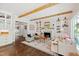 Bright living room with exposed wood beams, a fireplace, and built-in shelves at 3312 Rock Creek Dr, Raleigh, NC 27609