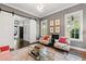Charming living room with sliding barn doors, patterned chairs, and a clear coffee table at 3312 Rock Creek Dr, Raleigh, NC 27609