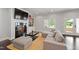 Cozy living room featuring dark hardwood floors, built-in bookshelves, and a fireplace at 3312 Rock Creek Dr, Raleigh, NC 27609