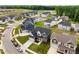 An aerial view of a new community, showcasing craftsman style homes with well-maintained lawns and proximity to green spaces at 3529 Bailey Lake Dr, Fuquay Varina, NC 27526