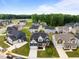 A beautiful community with craftsman style homes featuring lush green lawns and mature trees under a blue sky at 3529 Bailey Lake Dr, Fuquay Varina, NC 27526