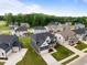 Aerial shot showcasing homes in a neighborhood with lush green landscaping at 3529 Bailey Lake Dr, Fuquay Varina, NC 27526