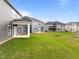 Large backyard with lush green grass and a view of surrounding homes at 3529 Bailey Lake Dr, Fuquay Varina, NC 27526