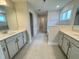 Bright bathroom featuring tile floors, double vanity with white countertops and gray cabinets at 3529 Bailey Lake Dr, Fuquay Varina, NC 27526