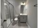 Clean, modern bathroom featuring a walk-in shower with glass door and a vanity with a bright mirror at 3529 Bailey Lake Dr, Fuquay Varina, NC 27526
