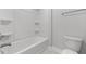 Bright bathroom features a shower-tub combo with built-in shelving and a modern toilet at 3529 Bailey Lake Dr, Fuquay Varina, NC 27526