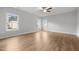 Spacious bedroom with hardwood floors, ceiling fan, and bright natural light at 3529 Bailey Lake Dr, Fuquay Varina, NC 27526