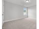 Neutral bedroom with plush carpeting, bright window, and ample natural light at 3529 Bailey Lake Dr, Fuquay Varina, NC 27526