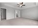 Spacious bedroom features a ceiling fan, neutral carpet, and an ensuite bathroom at 3529 Bailey Lake Dr, Fuquay Varina, NC 27526