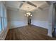 Elegant dining room featuring hardwood floors, detailed trim work, coffered ceiling, and a modern chandelier at 3529 Bailey Lake Dr, Fuquay Varina, NC 27526