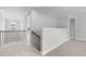 Upstairs hallway with carpeted floor and stair railing at 3529 Bailey Lake Dr, Fuquay Varina, NC 27526