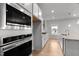 Bright, modern kitchen with stainless steel appliances, white cabinets and granite countertops at 3529 Bailey Lake Dr, Fuquay Varina, NC 27526