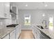 Bright kitchen featuring stainless steel appliances, granite countertops, modern cabinets, and ample counter space at 3529 Bailey Lake Dr, Fuquay Varina, NC 27526