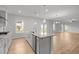 Open kitchen with island featuring granite countertops and stainless steel appliances at 3529 Bailey Lake Dr, Fuquay Varina, NC 27526