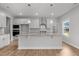 Modern kitchen with granite countertops, stainless steel appliances, white cabinetry, and a center island at 3529 Bailey Lake Dr, Fuquay Varina, NC 27526