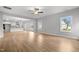 Open-concept living room with hardwood floors, ceiling fan, and seamless flow to the kitchen area at 3529 Bailey Lake Dr, Fuquay Varina, NC 27526