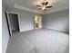 Spacious main bedroom featuring neutral paint, plush carpet, a tray ceiling, and ceiling fan at 3529 Bailey Lake Dr, Fuquay Varina, NC 27526