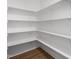 Walk-in pantry featuring custom built shelving and hardwood floors at 3529 Bailey Lake Dr, Fuquay Varina, NC 27526