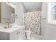 Bright bathroom with modern vanity, updated shower and gold fixtures at 3607 Springhollow Ct, Efland, NC 27243