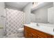 Cozy bathroom featuring wooden vanity, neutral tile floor and a shower/tub combo at 3607 Springhollow Ct, Efland, NC 27243