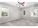 Bedroom featuring neutral walls, carpet, and natural light from two windows at 3607 Springhollow Ct, Efland, NC 27243