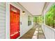 Covered front porch with classic painted red door offering a welcoming entryway at 3607 Springhollow Ct, Efland, NC 27243