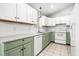 Bright kitchen featuring white cabinets, tile backsplash, and stainless steel appliances at 3607 Springhollow Ct, Efland, NC 27243